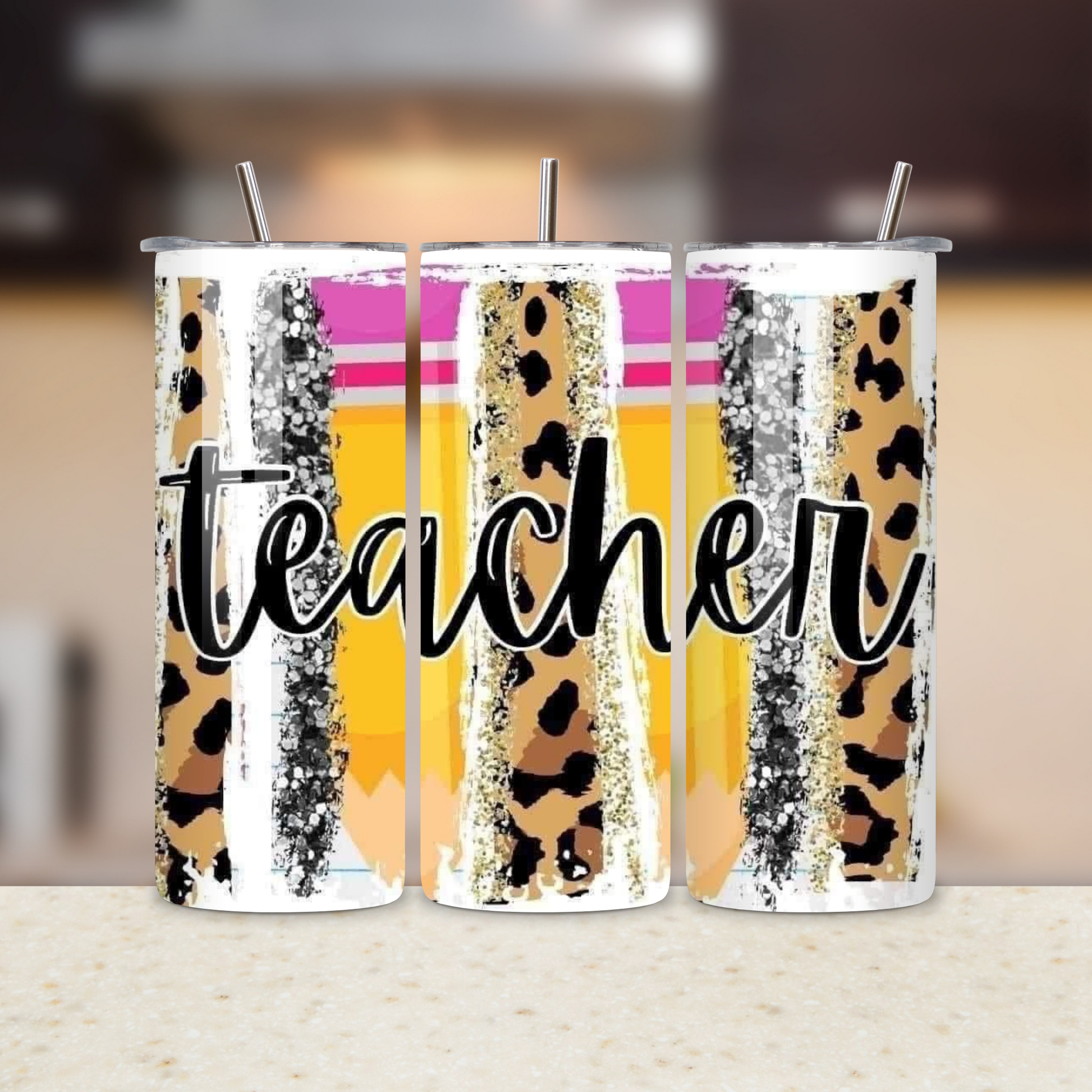 Three tumblers with leopard print and glitter patterns, featuring the word 'teacher'.