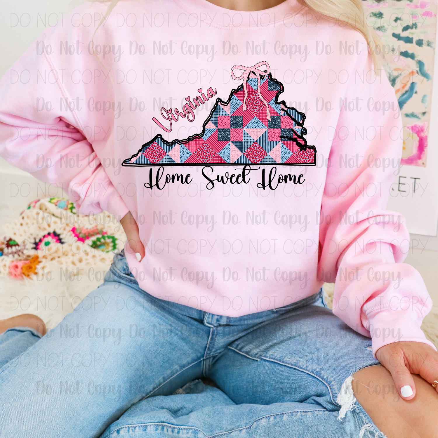 Person wearing a pink sweatshirt with a 'Virginia Home Sweet Home' design.