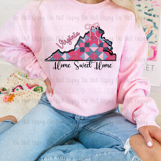 Person wearing a pink sweatshirt with a 'Virginia Home Sweet Home' design.