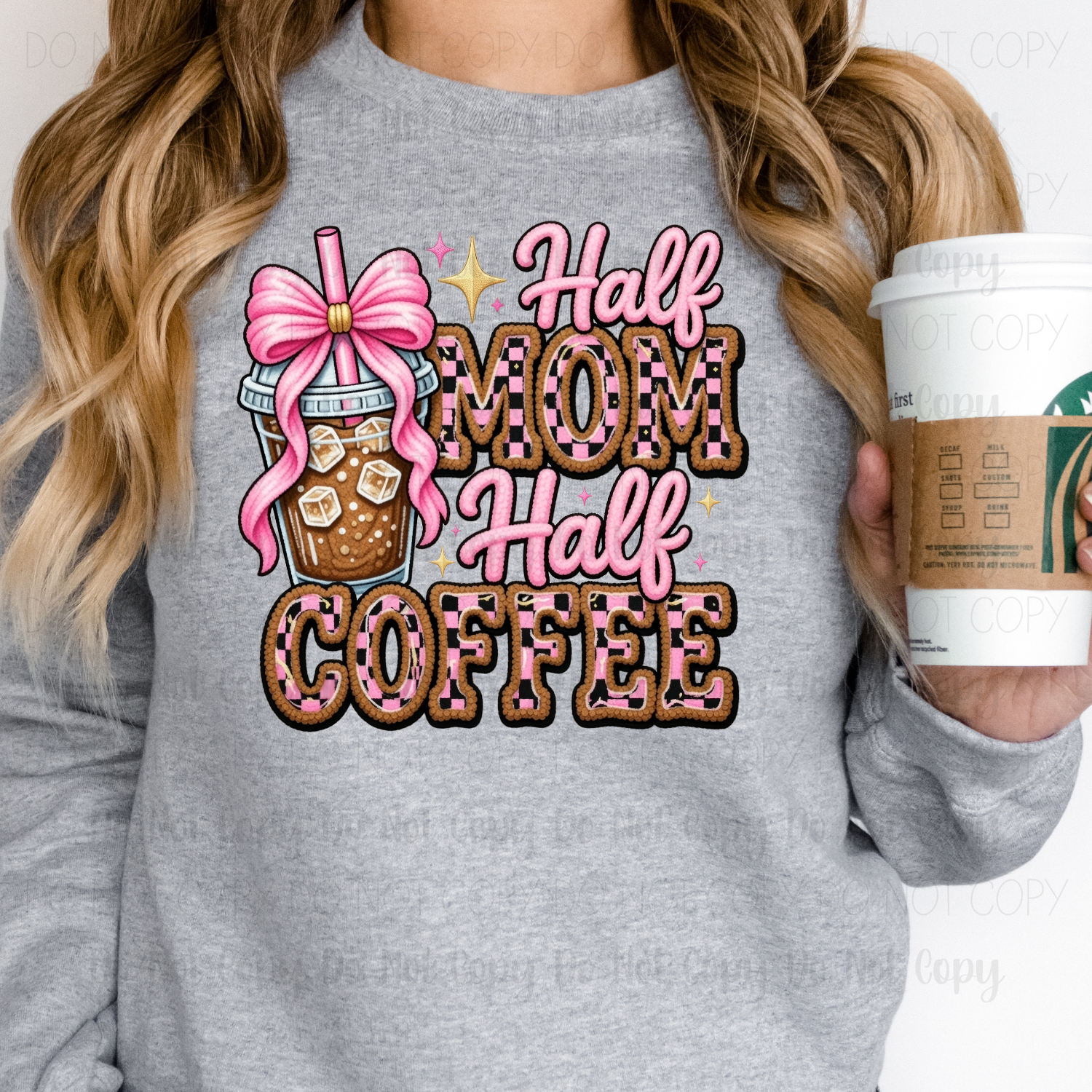 Person wearing a gray sweatshirt with 'Half Mom Half Coffee' design, holding a Starbucks cup.